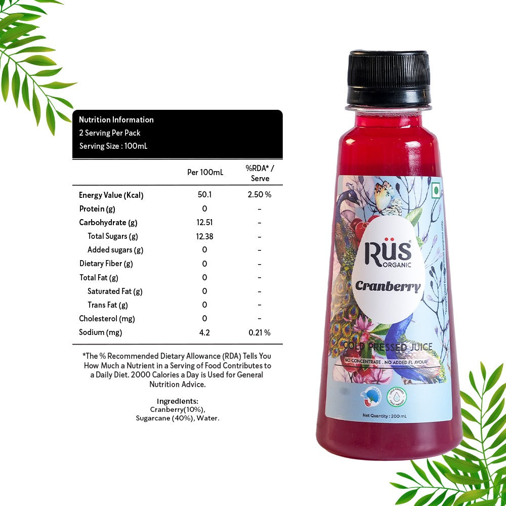 A single, clear plastic bottle filled with red Rus Organic Cranberry Juice. The bottle has a black cap and a colorful label featuring a peacock feather design, cranberries, blueberries, and the "Rūs Organic Cranberry" logo. The background is a solid gray