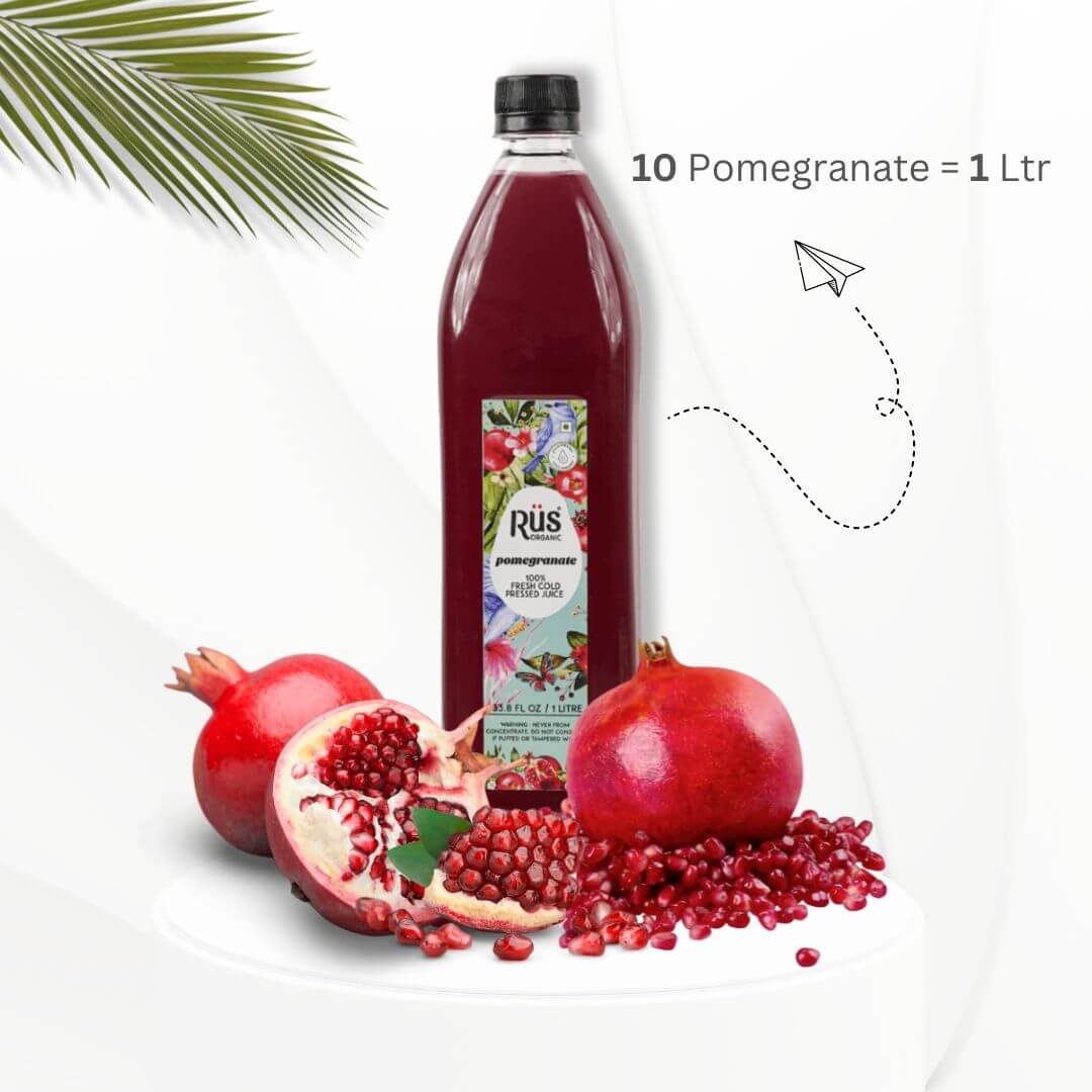 Bottle of Rus Organic Fresh Pomegranate Juice with pomegranates placed beside it, highlighting its freshness and natural ingredients