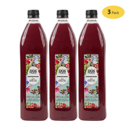 Bottle of Rus Organic Fresh Pomegranate Juice with pomegranates placed beside it, highlighting its freshness and natural ingredients